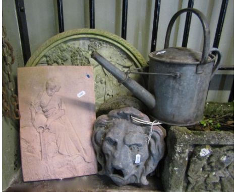 Small miscellaneous collection including galvanized iron watering can, a lead lion mask fountain head, a circular panel showi