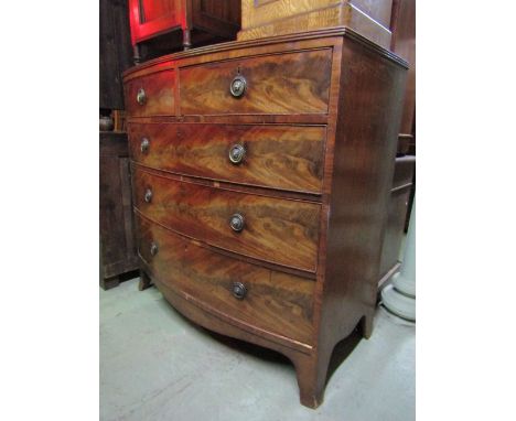 A Regency mahogany bow fronted bedroom chest of three long and two short graduated drawers with well matched flame veneers ov