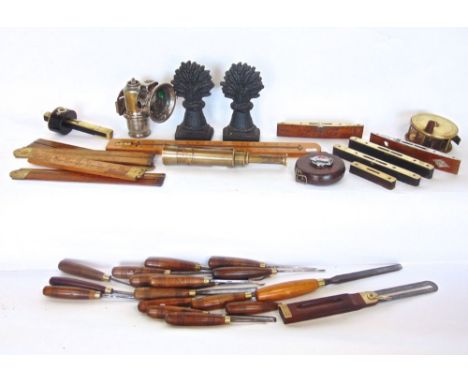 Box containing a collection of interesting items to include many rulers and measuring tools, antique brass fishing reel, pair