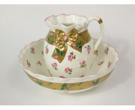 A Victorian Minton's jug and basin set with simulated gilt ribbon detail and printed and infilled rose sprays, with printed m