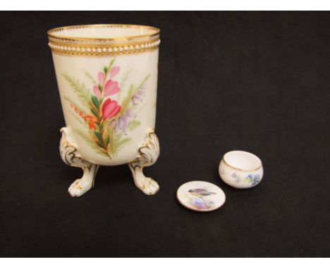 A Royal Worcester ivory ground vase of cylindrical form with painted violet and other wild flower decoration raised on three 