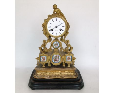 Good quality French ormolu two train figural drum head mantle clock, mounted by a recumbent cupids, raised upon floral scroll