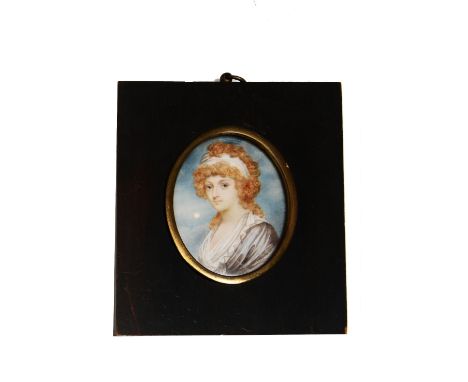 A late 18th century portrait miniature of oval form showing a bust length study of a young woman in a pale grey dress with wh