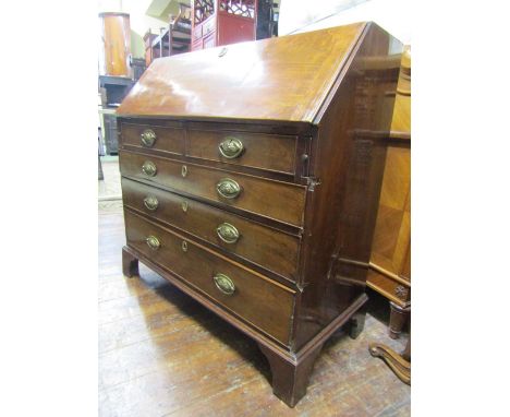 A Georgian mahogany bureau of three long and two short drawers, the fall flap enclosing a fitted interior of drawers, pigeon 