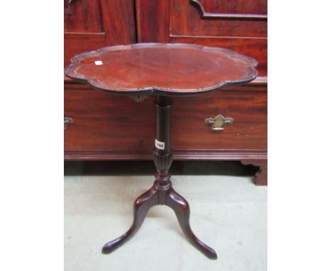 A Georgian style wine table, the circular tray top with scallop border raised on a vase shaped pillar and tripod, together wi