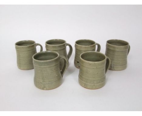A set of six St Ives Pottery mugs with pale buff coloured speckled glaze finish, impressed St Ives seal mark to base, 9cm tal