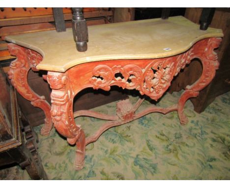 A console table with deep serpentine outline, pierced carved scrolling acanthus and grape frieze raised on four shaped suppor