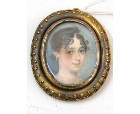 An early 19th century portrait miniature of a young lady with brown hair, understood to represent Miss Julia Jessop, 4cm max,