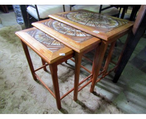 A nest of three vintage Danish teak occasional tables of rectangular form with inset hand painted tiled tops