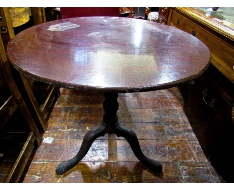 A Georgian mahogany snap top table raised on a turned pillar and tripod base