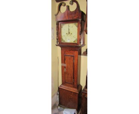 A 19th century cottage longcase clock in oak, cross banded in walnut enclosing a square painted dial and 30 hour striking mov