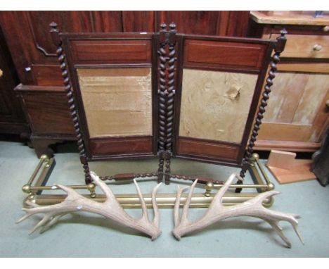 A Victorian mahogany freestanding two fold screen with sliding and partially upholstered panels and raised on spiral twist co