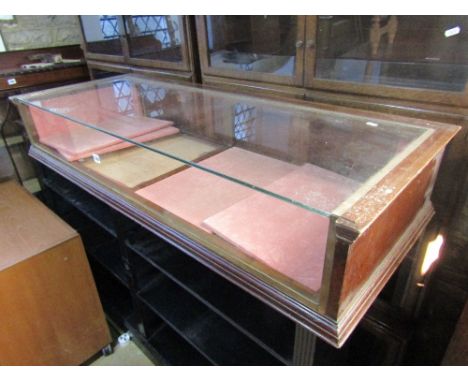 A vintage counter top display case of shallow rectangular form, the mahogany frame incorporating two doors with fall fronts, 