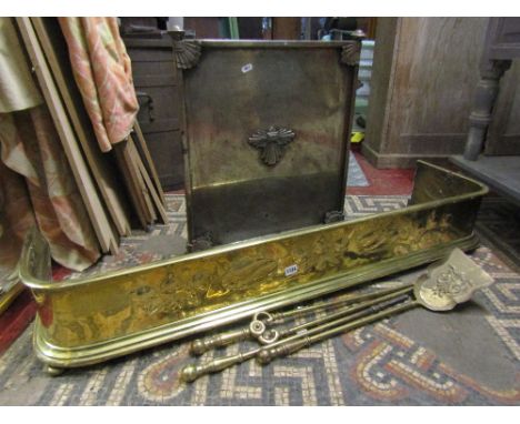 An Art Nouveau polished brass fender, 125 cm in length, brass shovel and an anodised firescreen