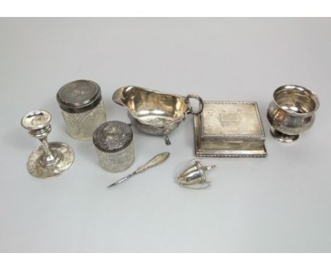 Open silver sauce boat, candlestick, two silver topped jars, cigarette case, etc