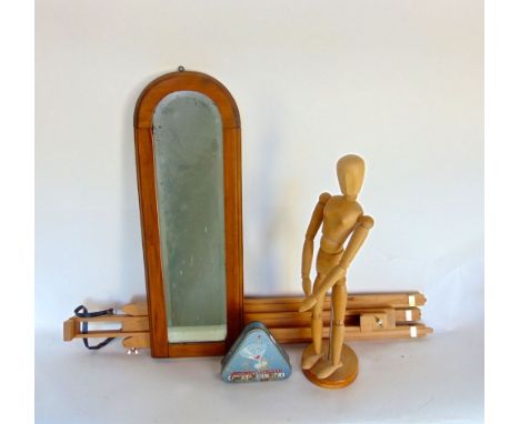 A tall artist dummy, upon a plinth base, 55cm high; together with an artists easel, an arched slim wall mirror and a tin (4)