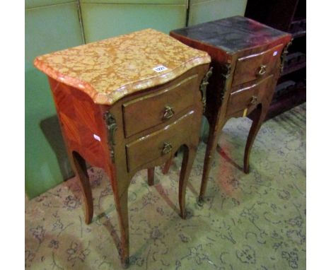 A pair of continental king wood side/lamp tables raised on shaped supports, each enclosing two drawers and set beneath shaped