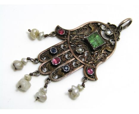 A silver gem set filigree pendant in the form of the hand of Fatima, set with square cut aquamarine, rubies and natural pearl