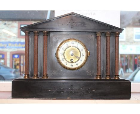 Belgian Slate mantel clock with column supports and Numeral Dial. 43cm in Diameter 