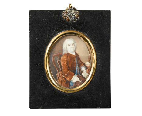 English School, circa 1760 Portrait miniature of a gentleman in brown coat, seated half-length in his study, holding a letter