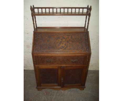 AN ANTIQUE BUREAU WITH GALLERY SHELF  AND CHIPPENDALE LATTICE STYLE DESIGN