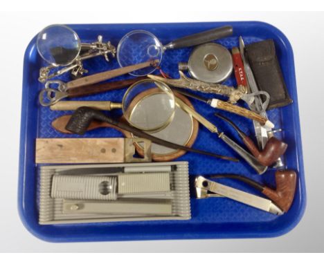 A group of collectables, letter knife in the form of a bayonet, magnifying glasses, bottle openers, pocket knife, hip flask e