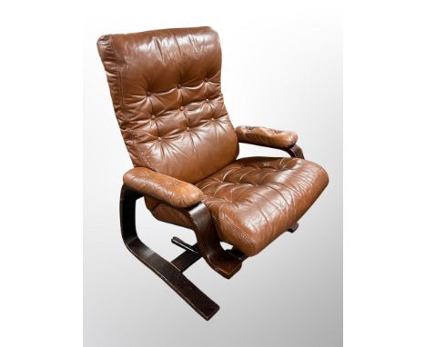 A 20th century Danish stained beech and buttoned tan leather manual reclining  armchair 