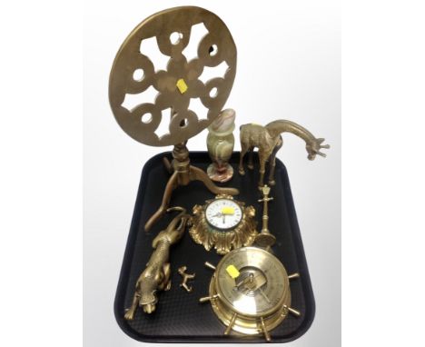 An ornate brass cased quartz timepiece together with a further ship's style barometer, brass animal ornaments, trivet, carved