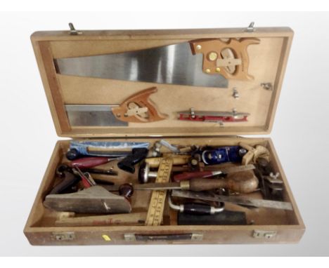 A joiner's toolbox and contents, hand saws, folding rules, wood working planes, Record etc 