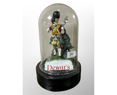 A Dewar's Scotch whisky advertising figure under glass dome, height 28 cm 