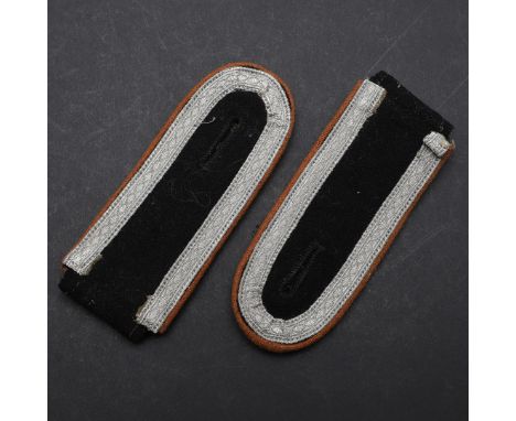 A PAIR OF SECOND WORLD WAR GERMAN WAFFEN-SS NCO'S SHOULDER STRAPS. A pair of Waffen-SS NCO's shoulder straps. Black felt with