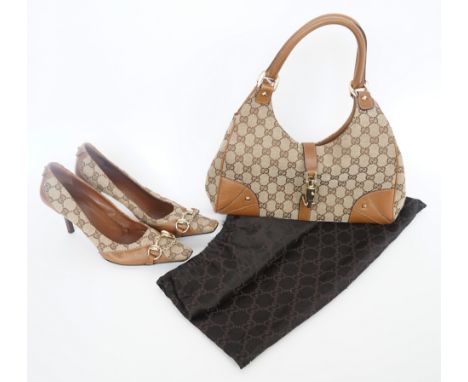 GUCCI: A JACKIE HOBO MONOGRAM HANDBAG AND MATCHING SHOES (2)In beige monogram canvas with tan brown leather straps and corner