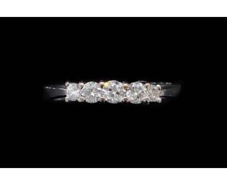 A DIAMOND FIVE STONE RINGClaw set with a row of circular cut diamonds graduating in size to the centre stone, detailed 18 CT,