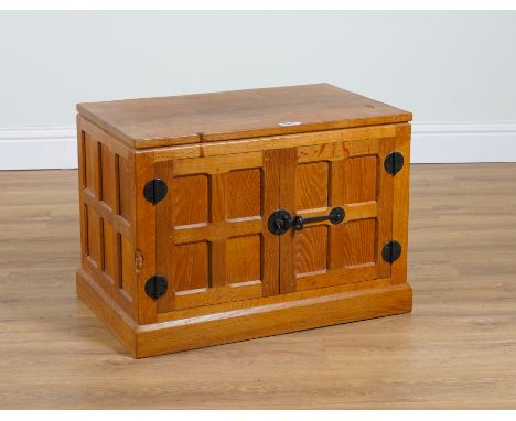 ROBERT MOUSEMAN THOMPSON OF KILBURN; AN ADZE OAK TWO DOOR SIDE CABINET ON PLINTH BASE73cm wide; 47cm deep; 51cm high