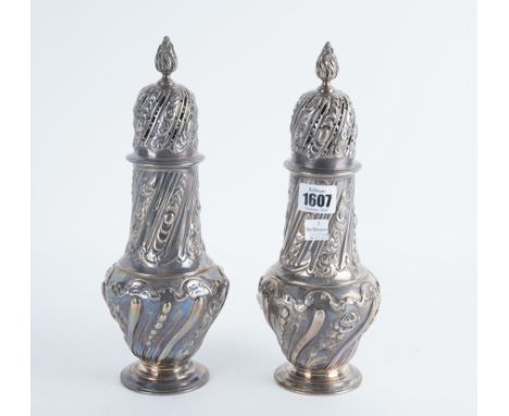 A PAIR OF LATE VICTORIAN SILVER LARGE SUGAR CASTERS (2)Each of pear shaped form, embossed with scrolling spiral bands, with a