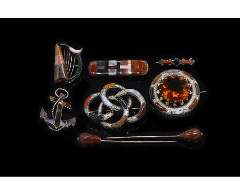 A GROUP OF EIGHT ITEMS OF SCOTTISH STYLE JEWELLERY (8)Comprising; six brooches including a varicoloured agate set anchor, a v