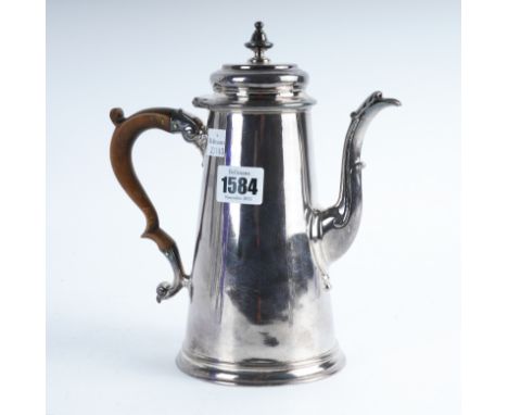 A GEORGE II SILVER COFFEE POTOf tapered cylindrical form, armorial engraved to the body with a wooden handle, London 1736, he