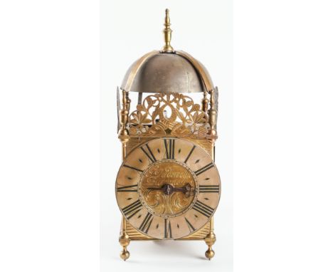 A GEORGE III BRASS LANTERN CLOCKBy Thomas Dadswell, Burwash, circa 1790Surmounted by a strapped bell and five finials, pierce