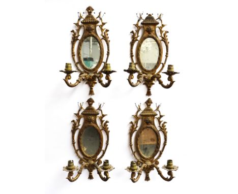 A SET OF FOUR GILT BRASS TWIN-LIGHT WALL APPLIQUES (4)19th CenturyEach with oval mirrored back, surrounded by acanthus mounte