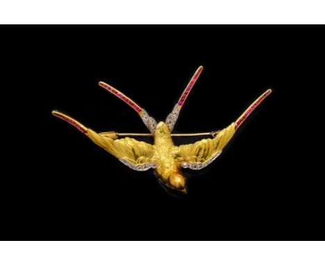 AN EDWARDIAN RUBY AND DIAMOND SET SWALLOW BROOCHDesigned as a bird in flight, mounted with rose cut diamonds and with rows of