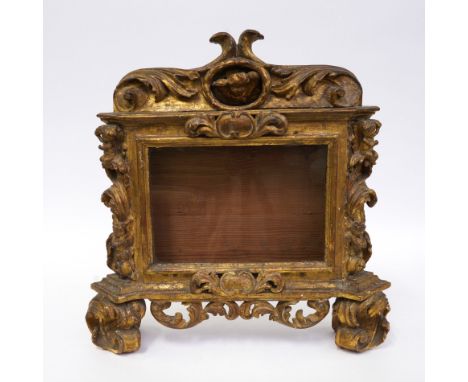 AN ITALIAN CARVED GILT-WOOD TABERNACLE FRAME19th Century The deep glazed panel with central reliquary aperture above, flanked