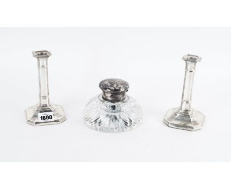 A PAIR OF SILVER CANDLESTICKS AND A SILVER MOUNTED GLASS INKWELL (3)Each candlestick of cut cornered rectangular form, with p