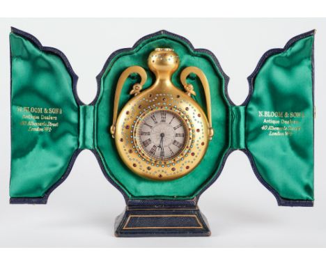 AN UNUSUAL VICTORIAN GILT-BRASS TURQUOISE AND PASTE SET STRUT TIMEPIECE IN THE FORM OF A TWIN-HANDLED URNRetailed by Howell, 