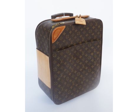 LOUIS VUITTON: A MONOGRAM CANVAS PEGASE TROLLEY SUITCASEThe small wheeled suitcase with gold hardware and tan leather detaili