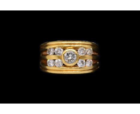 A GOLD AND DIAMOND RINGMounted with nine round brilliant cut diamonds, total estimated diamond weight 1.13 carats, in stamped
