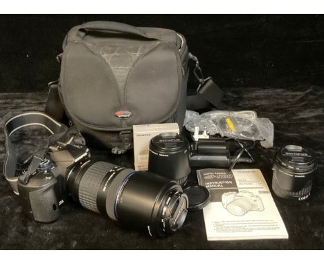 An Olympus E520 35mm camera outfit, including Olympus digital 70-300mm zoom lens 1:4 - 5.6 EDE, filter, lens hood; charging u