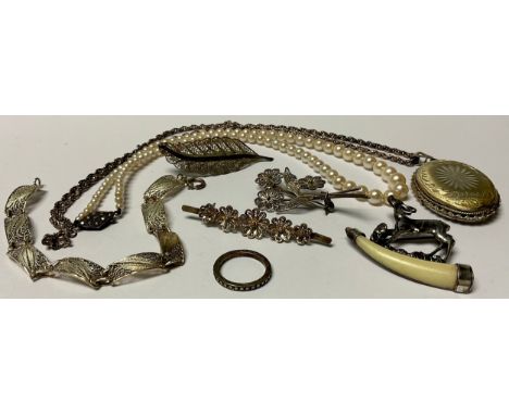 A silver oval locket pendant and chain, 20g; other silver filigree jewellery, ring, brooches, 20g; a single strand of graduat