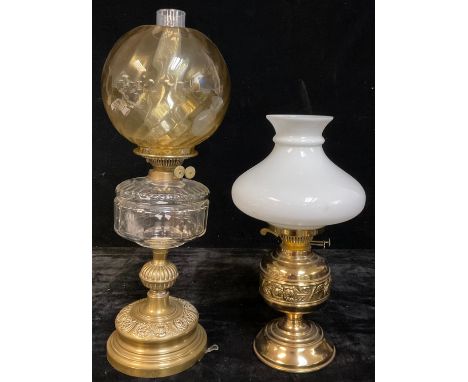 A late 19th/early 20th century Duplex oil lamp, clear glass font, knopped brass column and circular base embossed with scroll