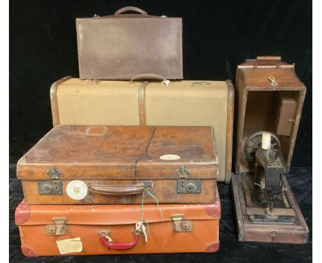 A late 19th/early 20th century leather suitcase, 61cm wide; a wooden bound suitcase/steamer trunk; other luggage; a Singer ha