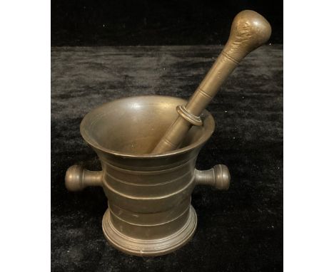 A bronze pestle and mortar 